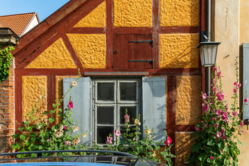 Fototapeta na wymiar Old restored half-timbered house with flowers