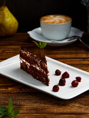 chocolate cake with berries on a white plate
