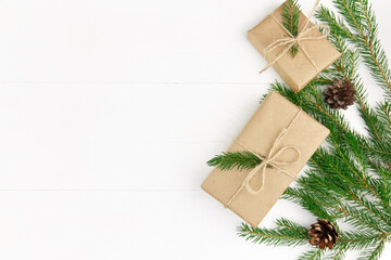 Christmas tree branches with cones and gift boxes. Winter holidays background.