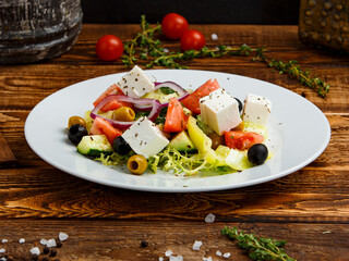 Greek salad on a wooden background