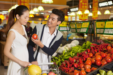 Fototapeta premium A young couple in the supermarket shopping
