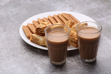 cutting masala chai or tea served with puff pastry/ khari and biscuits.