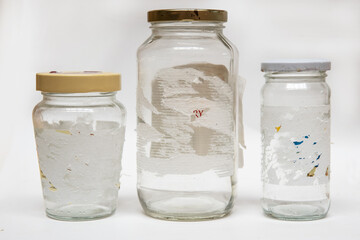 Removing sticky labels from glass jars. Hard to remove tags. Isolated on a white background