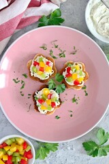 Canape or crostini with toasted bread, light cheese and colorful bell pepper. Top view with copy space.
