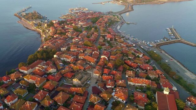 Aerial view of Nesebar old town, Bulgaria. Red tiled roofs of houses in the town of Nesebar. Island where the city is located is washed by the waters of the Black Sea