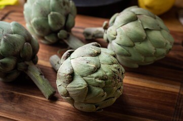 artichoke on wooden board at kitchen