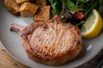 grilled pork chop with potato and salad