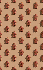 gingerbread pattern. Christmas bakery decor. Festive food background. Biscuit figure man with chocolate icing colorful ornament isolated on beige pastel.