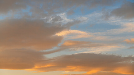 Naklejka na ściany i meble Beautiful colorful bright sunset sky with orange clouds. Nature sky background.