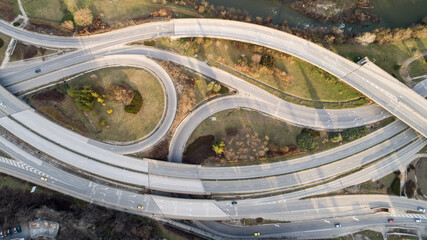 Top down view of highway multi level junction road with moving cars. View of traffic jam passing...