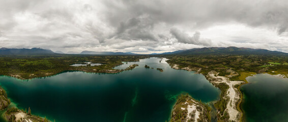 Beautiful Panoramic View of Scenic Lake, Islands and Forest in Canadian Nature. Aerial Done Shot taken near Klondike Highway. Lewes Lake, South of Whitehorse, Yukon, Canada. © edb3_16