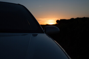 Fototapeta na wymiar silhouette of car at sunset. Backlighting