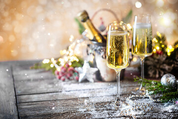 Champagne glasses and christmas decor on sparkling holiday background