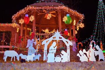 Christmas decoration: pergola with snowflakes, Christmas balls, a Christmas tree and a nativity...