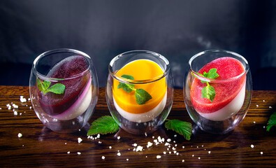 set of dessert panna cotta on wooden table. Delicious Italian dessert served for three