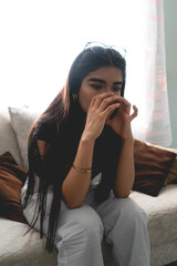 sad woman with hands over face