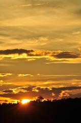Sunset view with beautiful golden sky,the colorful sky lights in the evening
