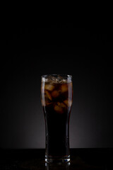 Glass of pop soda drink in a studio shot.