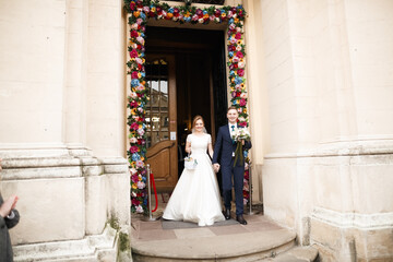 Married couple posing in a church after ceremony