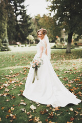 Fototapeta premium Bride holding big and beautiful wedding bouquet with flowers