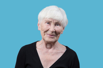 Portrait of an elderly woman on a blue background.