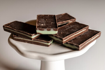 mint chocolate squares stacked on white plate
