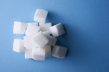 top view of white sugar cube on blue background