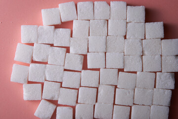top view of white sugar cube on  pink background