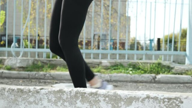 follow-up shot of slim young fitness runner in sportswear running up the ladder. closeup on legs of fit sportive female in activewear. sports, healthy lifestyle. woman runs upstairs, back view