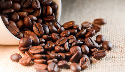 roasted coffee beans, (selective focus on coffee beans), with raffia sack