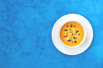 Pumpkin soup on blue background