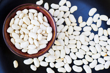 Healthy white beans on the dark background