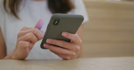 Woman use of mobile phone at restaurant