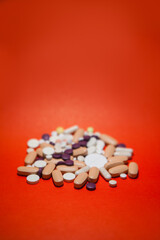 Various pills macro on red background. Top view