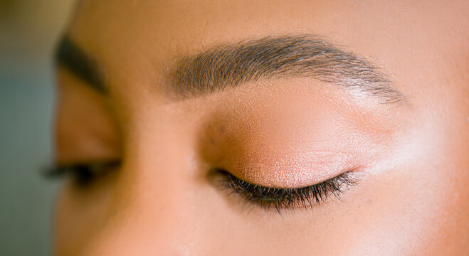 Eyebrow correction. Perfect natural eyebrows and eyelashes. Lush eyebrow. Natural make up. Beauty. Eyebrow and eyelashes close up.