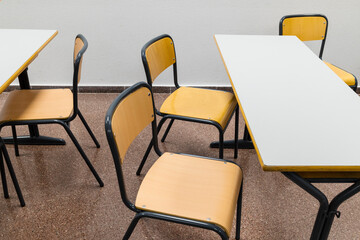 classroom with empty tables and chairs