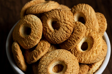 Ring Coconut biscuits served in a bowl. Brazilian little donut. Selective focus in a top view