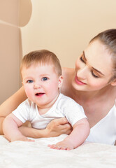 Mother and baby playing and smiling. Happy family.Home interior.