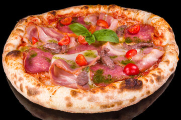 Delicious pizza with pesto, bacon, sausage, and cherry tomatoes with reflection,