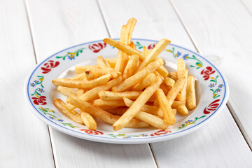 golden french fries on the wooden background