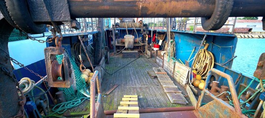 Fototapeta premium Deck of a sea trawler. Nets, winches and other equipment on view.