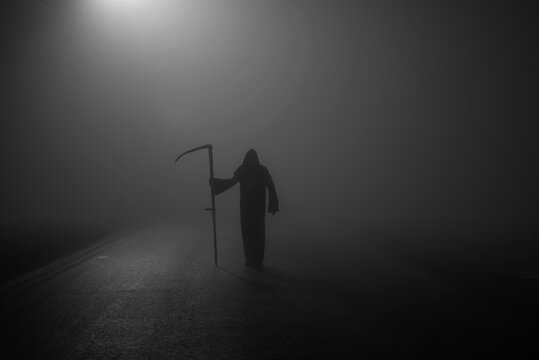 Death grim Reaper skeleton wearing a black robe and wielding a scythe, Memento Mori, Coronavirus, Epidemic Pandemic Time