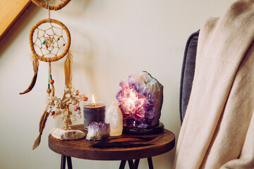 Relaxing home shrine with relaxing objects, amethyst cluster geode lamp illuminated, scented candle burning, selenite tower stone, crystal wire tree and dream catcher. - obrazy, fototapety, plakaty