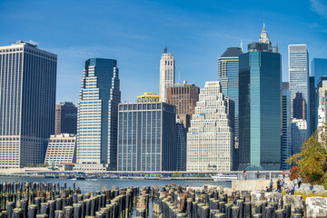 Fototapeta na wymiar NEW YORK CITY - OCTOBER 2015: View of Downtown Manhattan Skyscrapers from Brooklyn Bridge Park on a beautiful autumn day