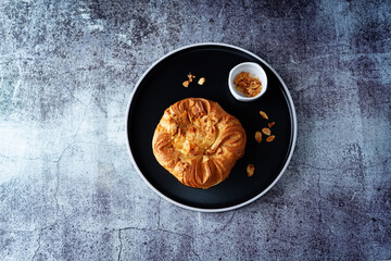 Vanilla cream almonds sweet bun in a plate