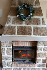 Fireplace insert in a living room with a Christmas wreath
