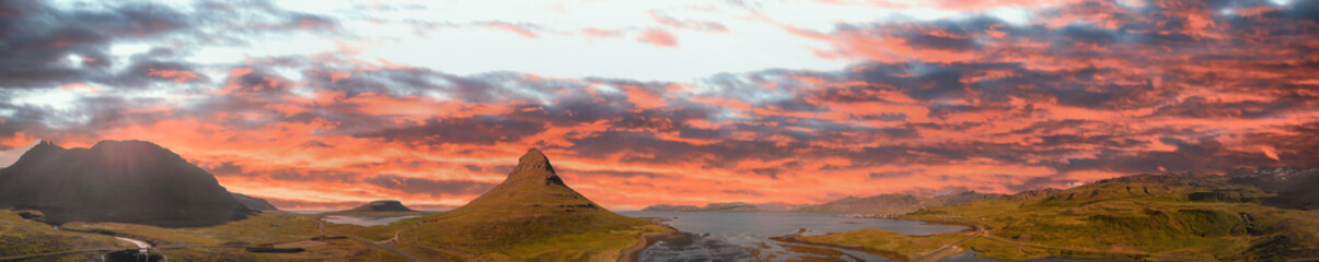 Fototapeta premium Sunset sky colors over Kirkjufell Mountain, panoramic aerial view