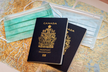 Canadian passport with covid-19 masks with travel theme. 