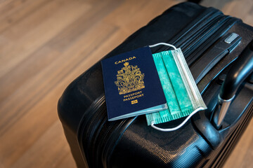 Canadian passport with covid-19 masks with travel theme.  © Jeff Whyte