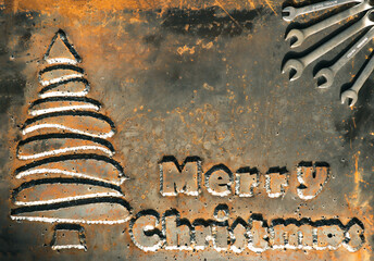 Merry christmas greeting board. Metal board with an iron tree, wrenches and a steel phrase 